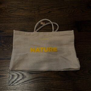 Clarins Beige Canvas Tote Bag with Yellow 'Nature' Print